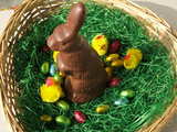 Easter bunny, made of swiss chocolate, amidst Easter chicks and Easter eggs