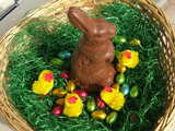 Easter hare, made of swiss chocolate, amidst Easter chicks and Easter eggs