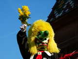Carnival of Basel 2008, a big nose Waggis giving mimosa flowers