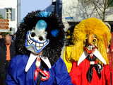 Carnival of Basel 2011, a Waggis with black hair and blue shirt, a Waggis with yellow hair and red shirt.