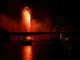 Firework on the Rhine 2006, red fountain, behind the Johanniterbruecke and many boats, eve of 1st August, Basle, Switzerland