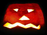 Halloween, carved turnip with light inside at night 