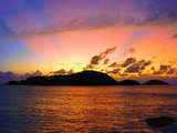Unforgettable tropical sunset, the sun is behind the island so it's almost after sunset, Seychelles, west coast of main island Mahe